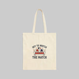 Beige tote bag with 'Off to Watch the Match' text and graphic on a white background